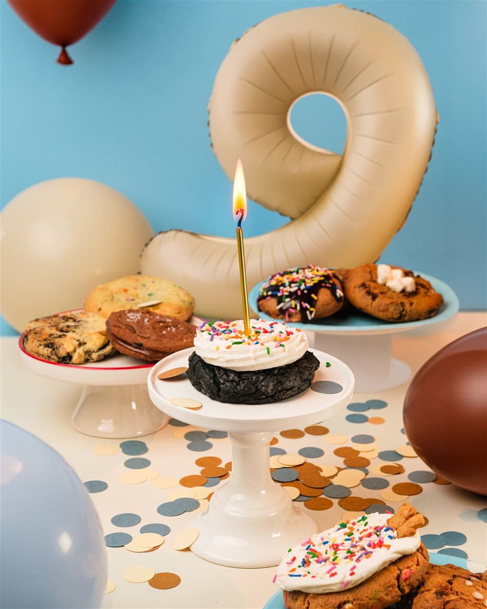 Chip City birthday cupcake cookie with a candle, balloons and confetti